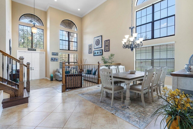 dining space featuring crown molding, a notable chandelier, light tile patterned flooring, and a wealth of natural light