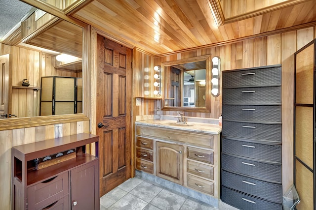 bathroom with vanity, wooden ceiling, tile patterned floors, and wood walls