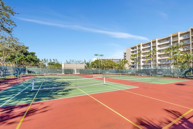 view of tennis court with basketball hoop