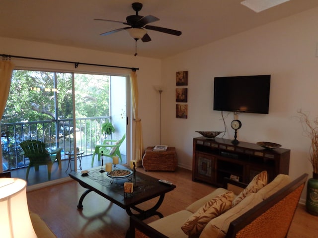 living room featuring ceiling fan and light wood-type flooring