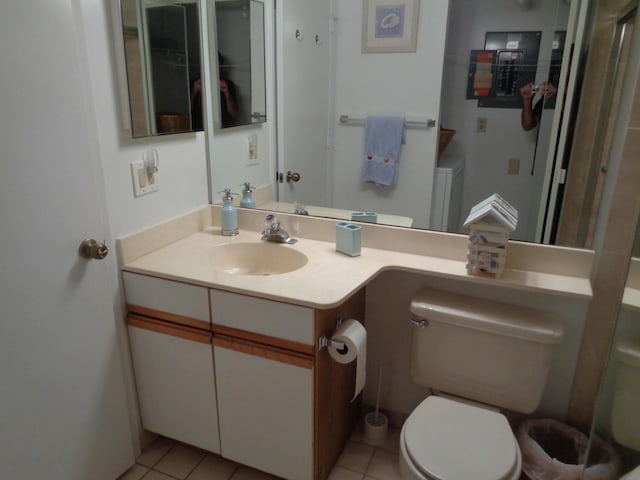 bathroom featuring tile patterned flooring, vanity, and toilet