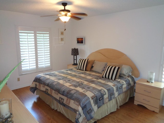 bedroom with hardwood / wood-style floors and ceiling fan