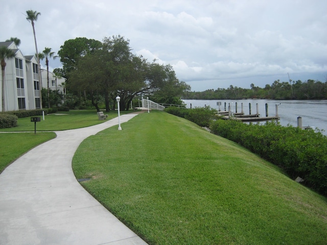 view of property's community featuring a yard and a water view