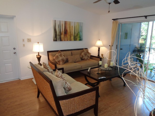 living room featuring ceiling fan and hardwood / wood-style floors