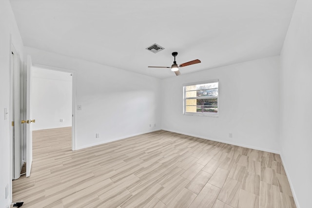 unfurnished room with light wood-style flooring, visible vents, ceiling fan, and baseboards