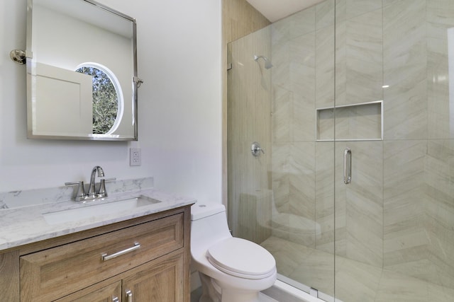 bathroom with vanity, toilet, and walk in shower