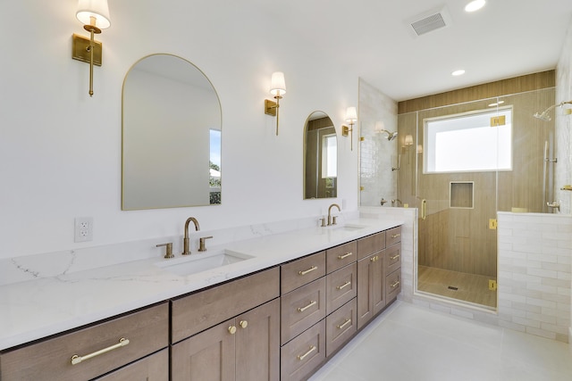 bathroom with vanity, an enclosed shower, and tile patterned flooring