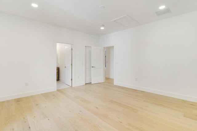 spare room featuring light hardwood / wood-style floors