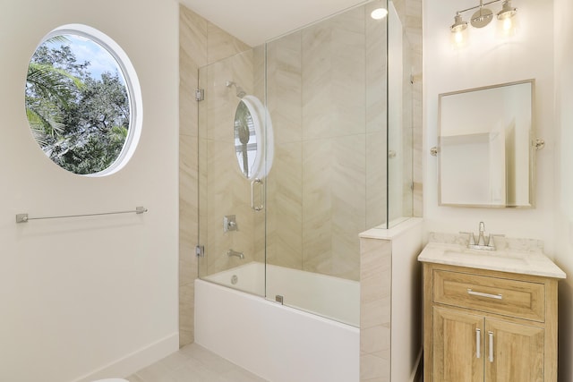 bathroom with vanity and combined bath / shower with glass door