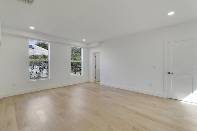 empty room with light hardwood / wood-style flooring