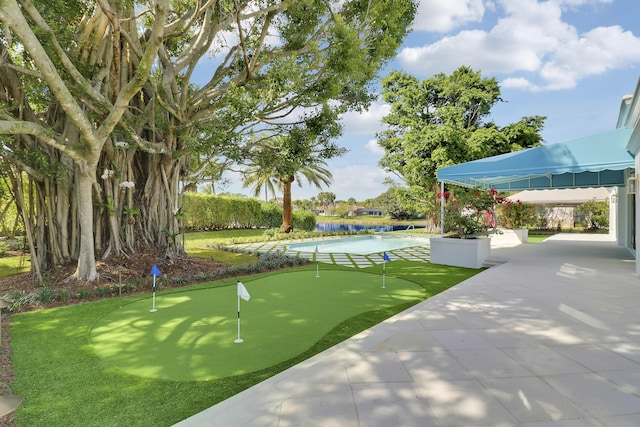 view of property's community featuring a water view, a swimming pool, and a patio area