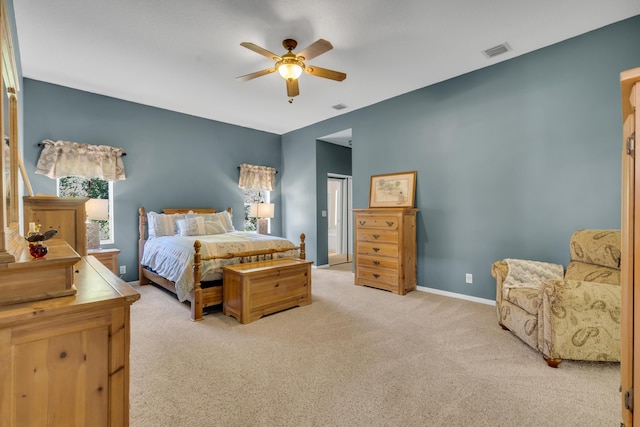 carpeted bedroom with a ceiling fan, visible vents, and baseboards