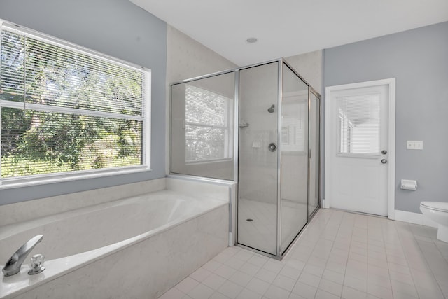 bathroom featuring independent shower and bath, tile patterned floors, and toilet