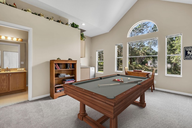 game room featuring light carpet, high vaulted ceiling, baseboards, and a sink