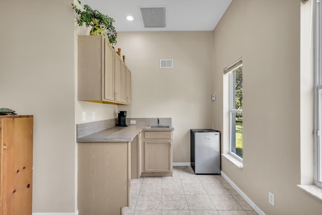 kitchen with plenty of natural light, visible vents, a sink, and light tile patterned flooring