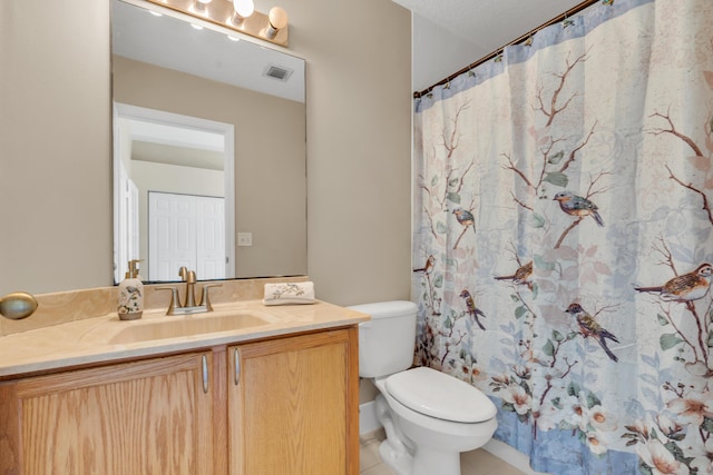 bathroom featuring tile patterned flooring, vanity, curtained shower, and toilet