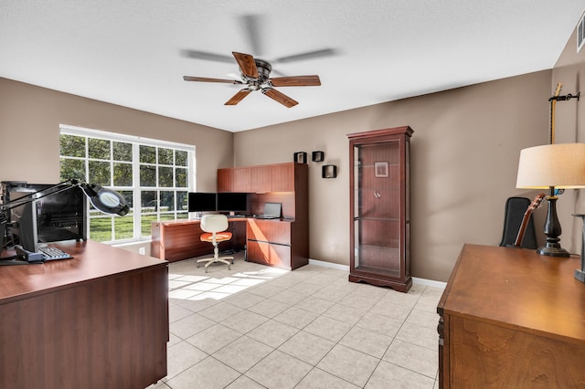 office featuring light tile patterned floors, ceiling fan, visible vents, and baseboards