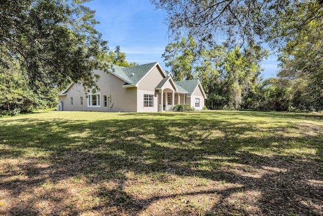 view of front of property with a front yard and stucco siding