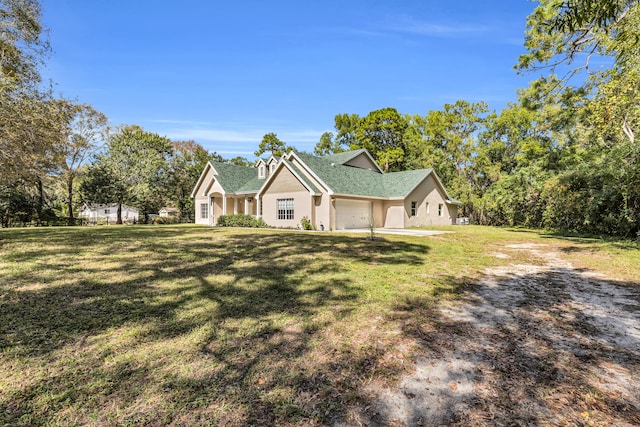 view of front of home with a garage and a front yard