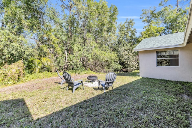 view of yard featuring an outdoor fire pit