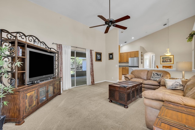 living area with baseboards, high vaulted ceiling, a ceiling fan, and light colored carpet