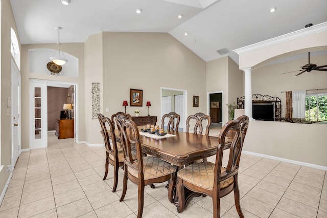 tiled dining room featuring french doors, ceiling fan, high vaulted ceiling, and decorative columns