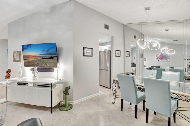 dining space featuring lofted ceiling