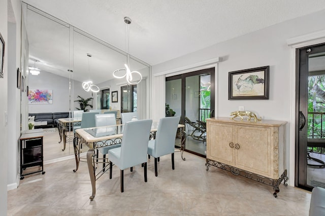 dining room with lofted ceiling and a textured ceiling