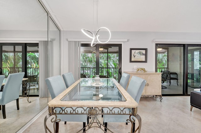 dining area featuring light tile patterned flooring and an inviting chandelier