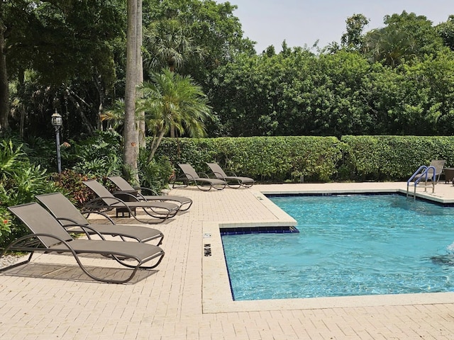 5540 Coach House Cir Unit F, Boca Raton, FL 33486 - view of pool featuring a patio area and view of scattered trees