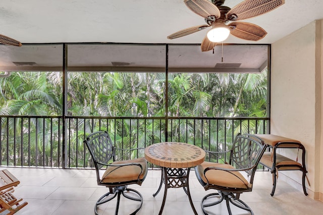 sunroom / solarium featuring plenty of natural light and ceiling fan