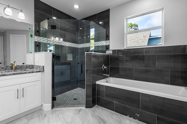 bathroom featuring vanity and independent shower and bath