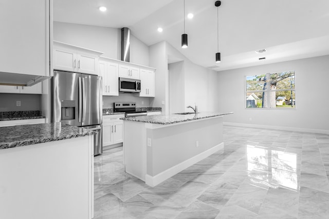 kitchen featuring pendant lighting, sink, appliances with stainless steel finishes, white cabinetry, and a center island with sink