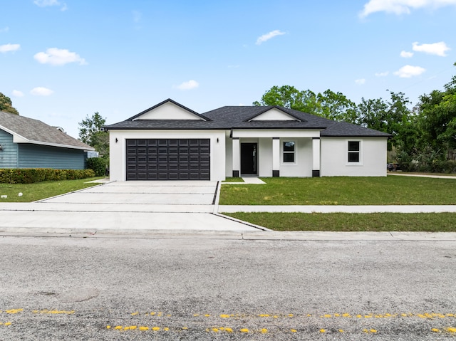 view of front facade with a garage and a front lawn