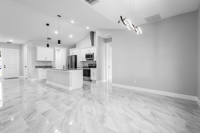 kitchen with pendant lighting, white cabinetry, stainless steel appliances, and an island with sink