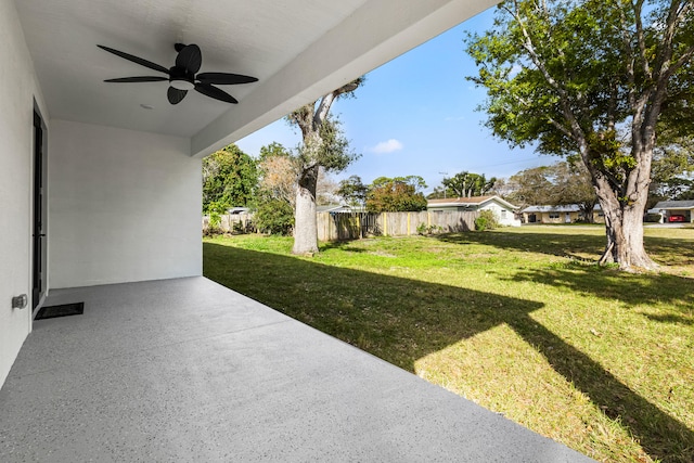 view of yard featuring ceiling fan and a patio area