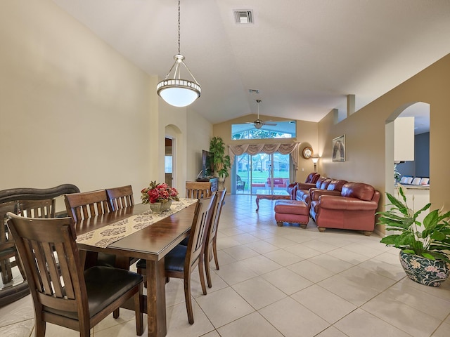 dining space with lofted ceiling and light tile patterned floors