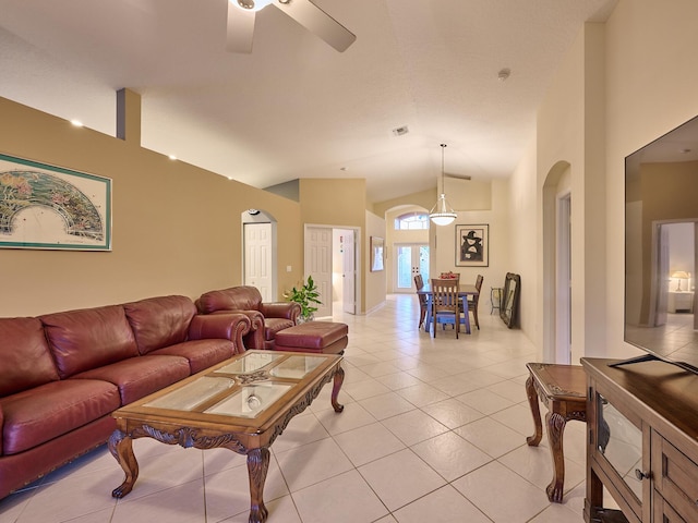 living room featuring ceiling fan, light tile patterned floors, and high vaulted ceiling