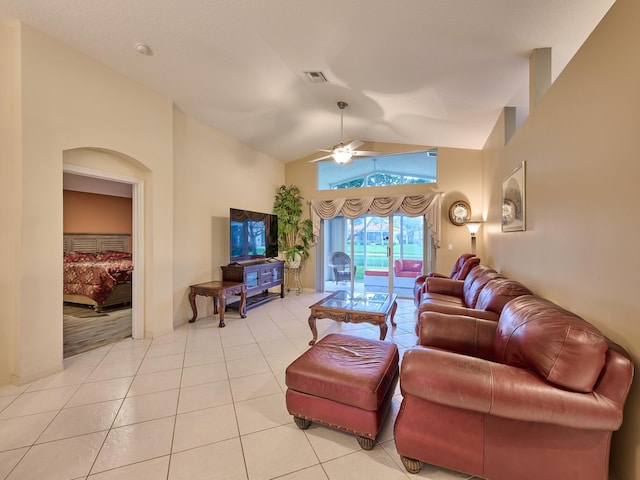 tiled living room featuring ceiling fan and high vaulted ceiling