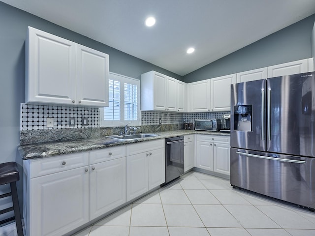 kitchen with sink, stainless steel fridge, black dishwasher, decorative backsplash, and white cabinets