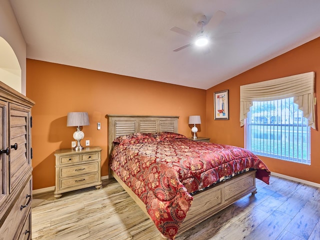 bedroom featuring lofted ceiling, ceiling fan, and light wood-type flooring