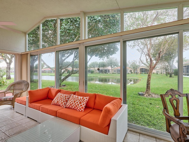 sunroom featuring vaulted ceiling and a water view