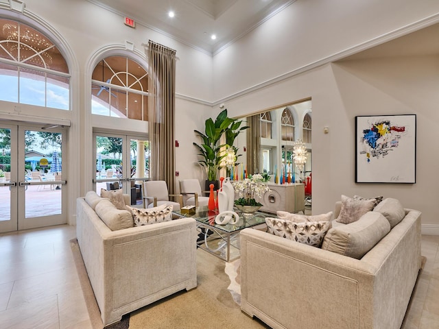 living room with crown molding, french doors, and a high ceiling