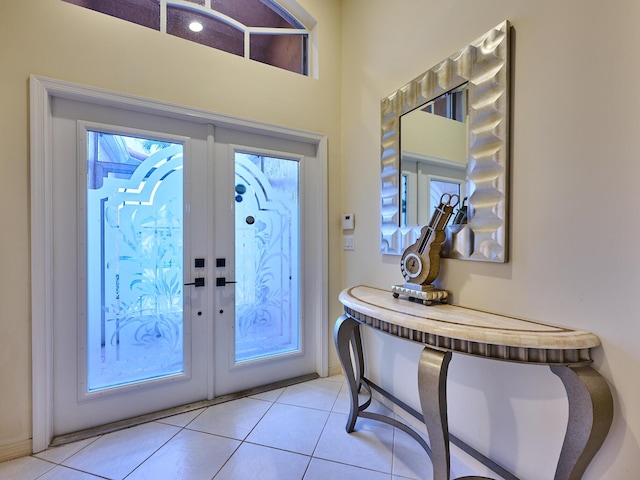 foyer entrance with light tile patterned floors and french doors