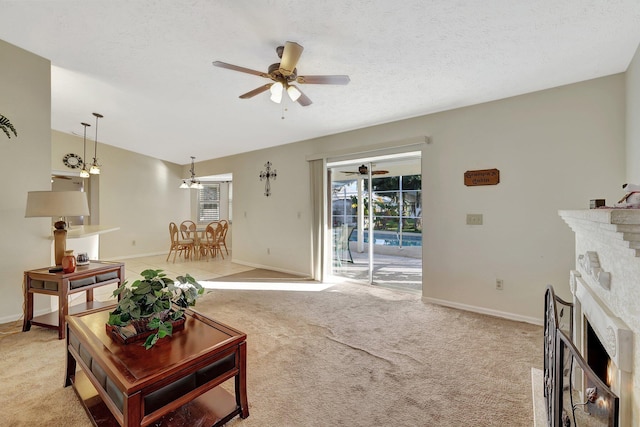 carpeted living room featuring a textured ceiling, a brick fireplace, and a wealth of natural light