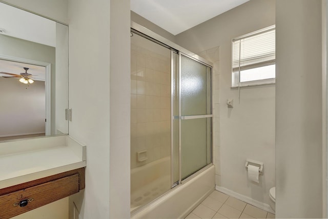 full bathroom with tile patterned floors, toilet, shower / bath combination with glass door, vanity, and ceiling fan