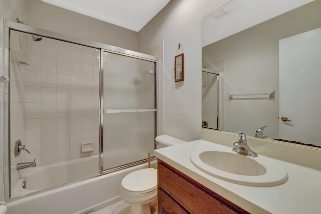 full bathroom featuring vanity, enclosed tub / shower combo, and toilet