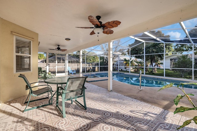 view of pool with a patio and glass enclosure