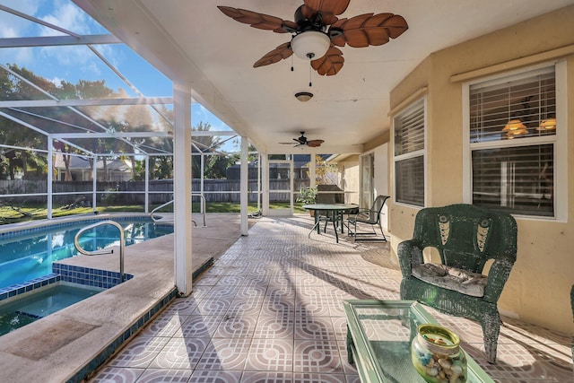 view of patio featuring a swimming pool with hot tub and glass enclosure