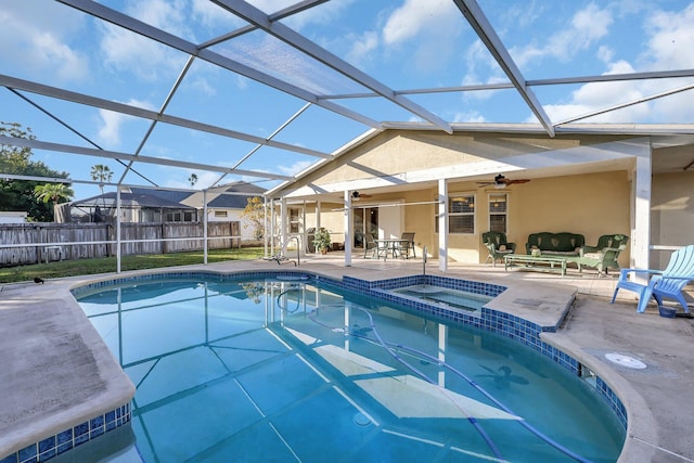 view of swimming pool featuring a lanai, a patio area, ceiling fan, and an in ground hot tub